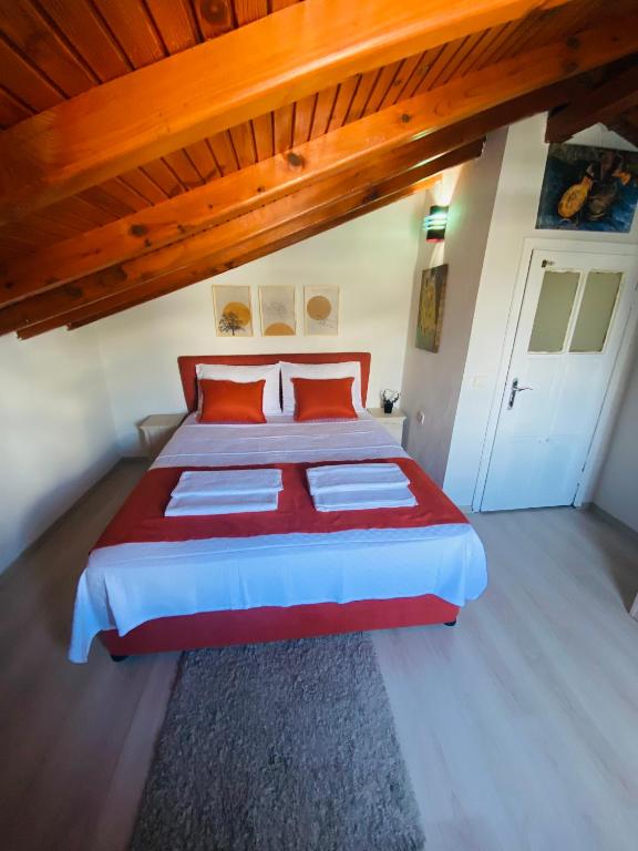 a bedroom with a large bed with red pillows at Ceres26 in Fethiye
