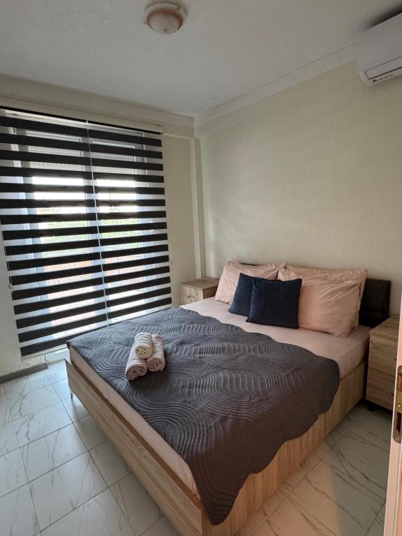 a bedroom with a large bed with a hat on it at Apartments Slavica in Ohrid