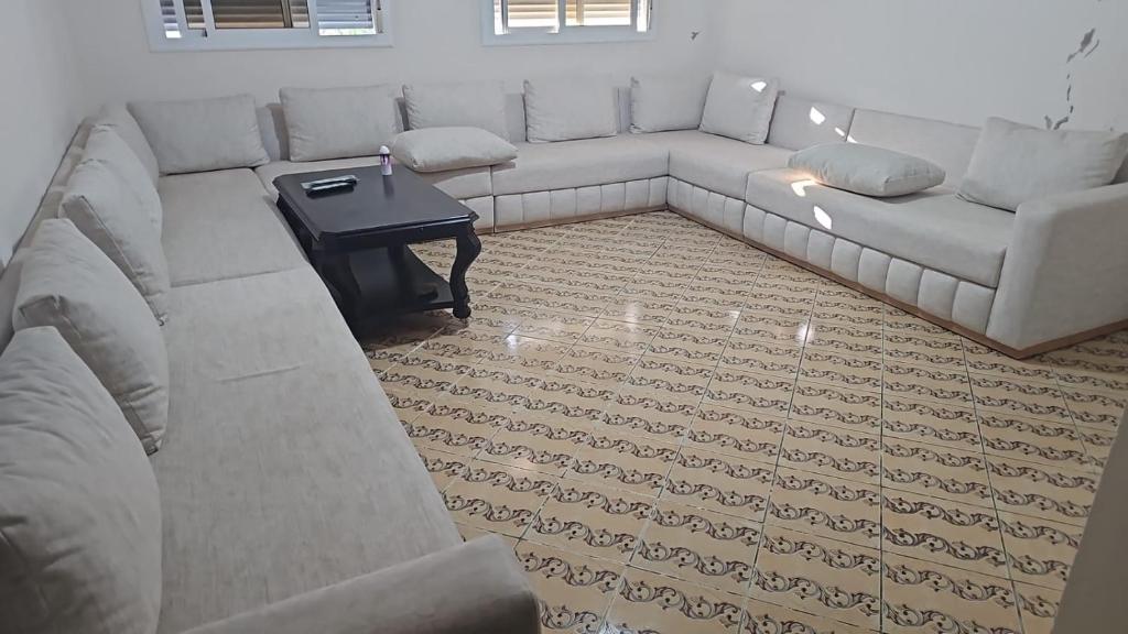 a living room with a couch and a table at La Casa de Madrid in Larache