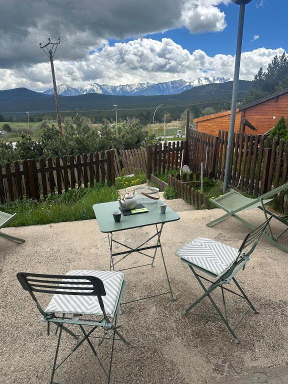 a table and two chairs and a table and chairs at Chalet N5 avec vue in Les Angles