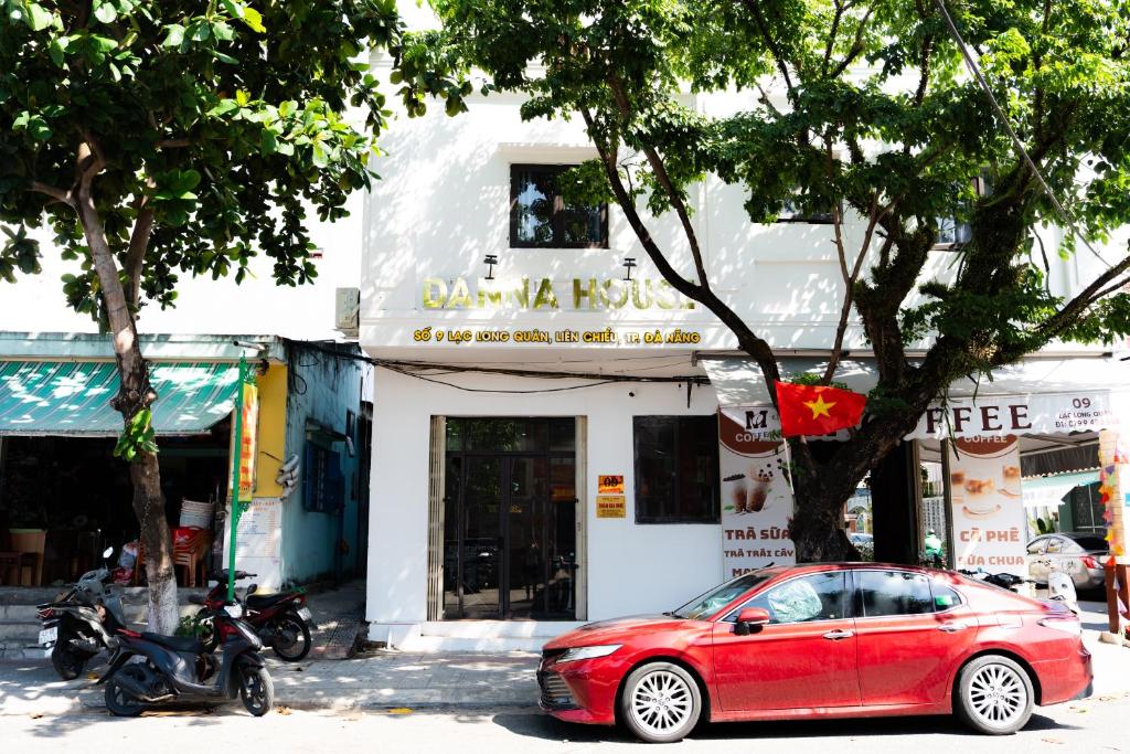 a red car parked in front of a building at Danna House Da Nang BNB in Danang
