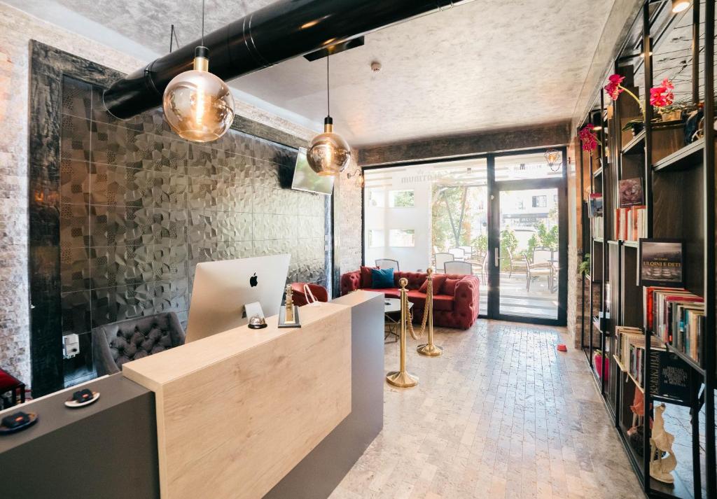 a living room with a desk and a couch at Hotel Platino Prestige in Ulcinj