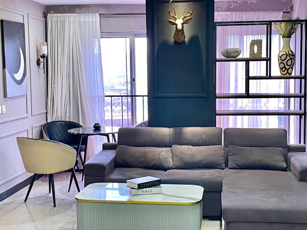 a living room with a couch and a table at 2BHK Apartment Perfect for Families & Groups in Rawalpindi