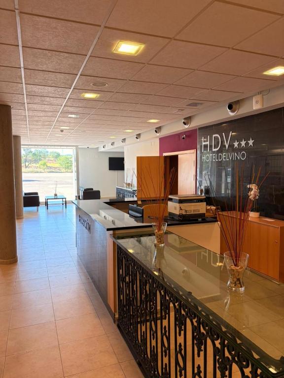 a lobby with a counter with vases on it at Hotel del Vino in Cariñena