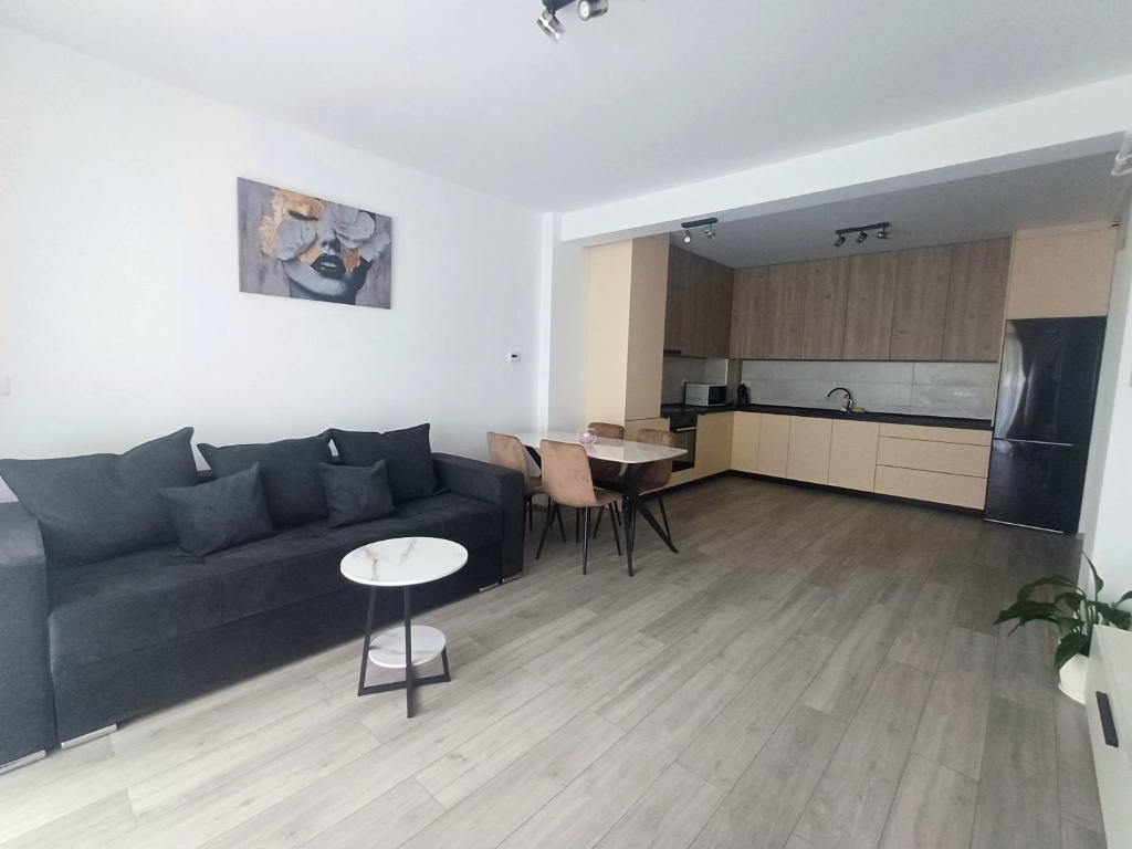 a living room with a couch and a table and a kitchen at AMA Home in Sebeş