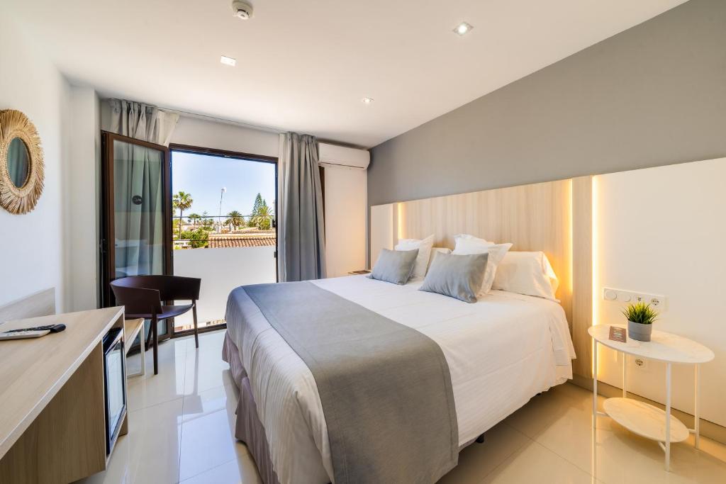 a hotel room with a large bed and a balcony at Soul Beach Hotel By Mc - Adults Recommended in Denia