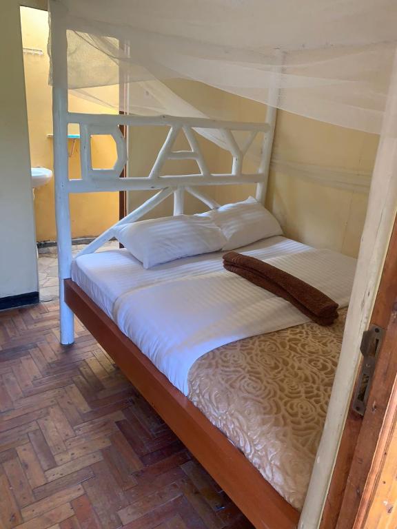 a bedroom with a bunk bed with white sheets at Essie Rovers Camp in Talek