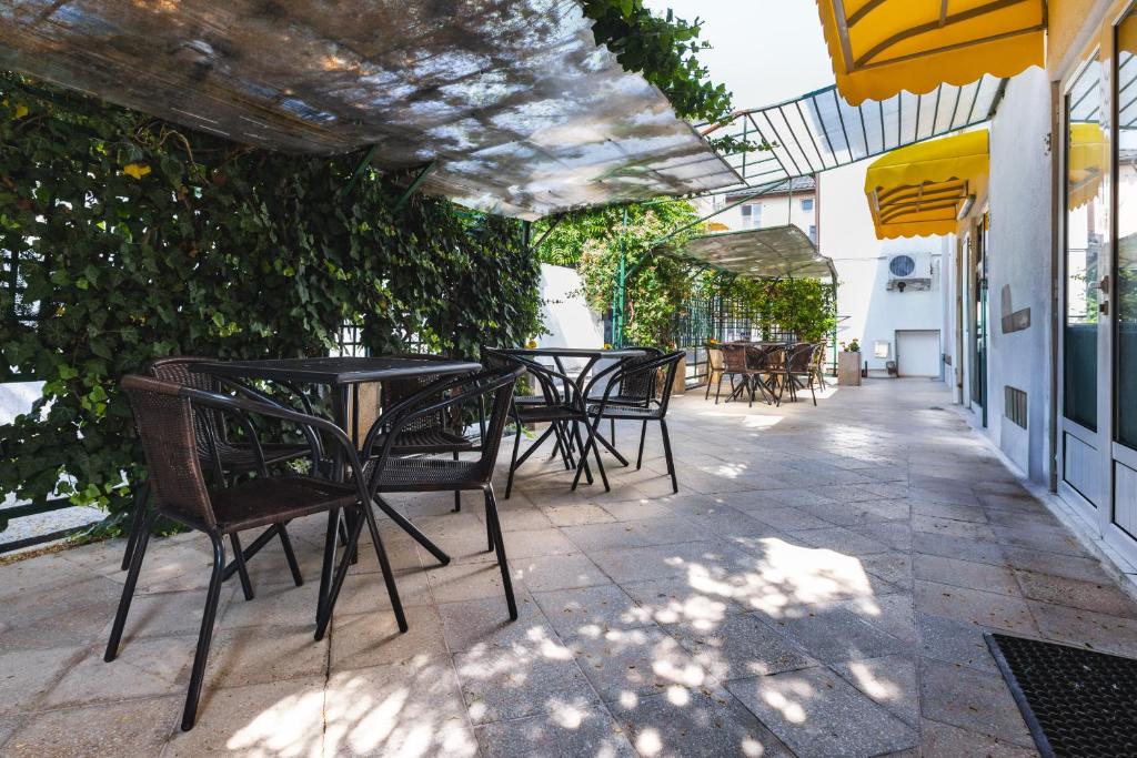 a patio with tables and chairs on a building at Casa Galbena Paflora Saturn in Saturn