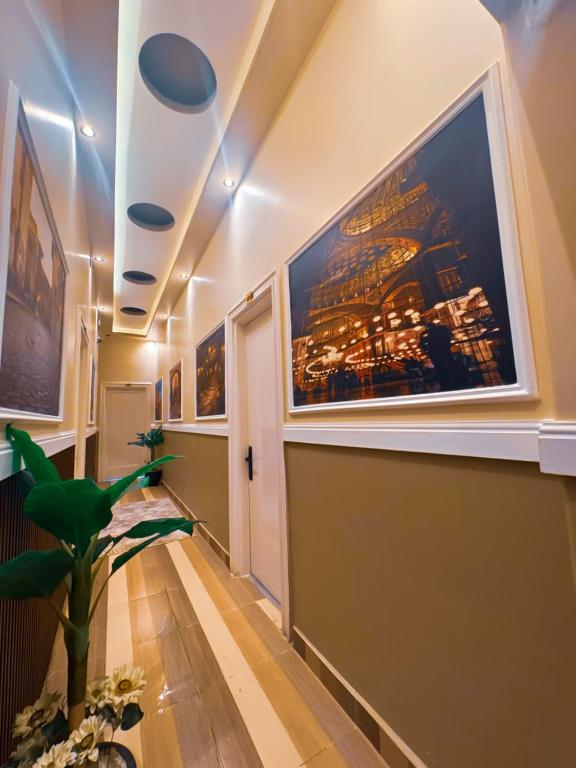a hallway with a large painting on the wall at Golden Palace Suites in Cairo