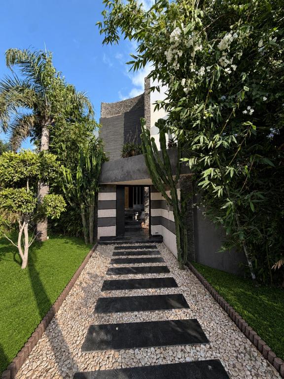 a garden with a pathway leading to a house at Riad Villa Elizabeth in Nouaseur