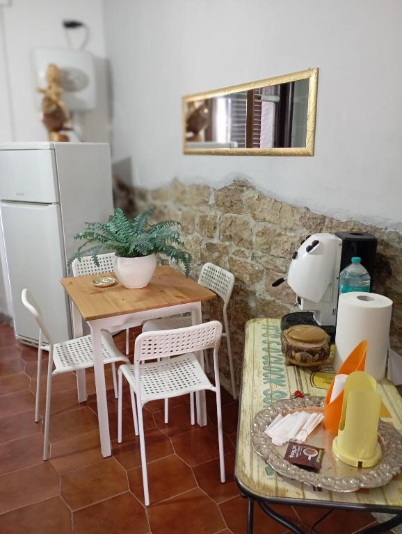 a kitchen with a wooden table and chairs and a table and a table at Bed And Breakfast ARIS in Benevento