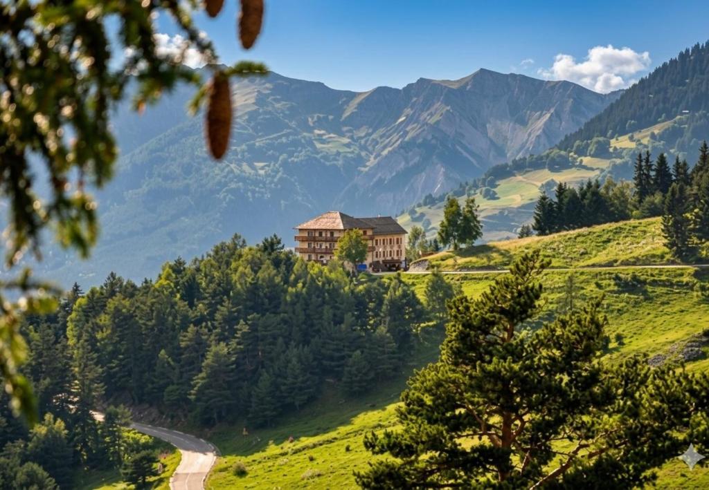 a house on a hill with mountains in the background at Auberge du Belvédère in Séez