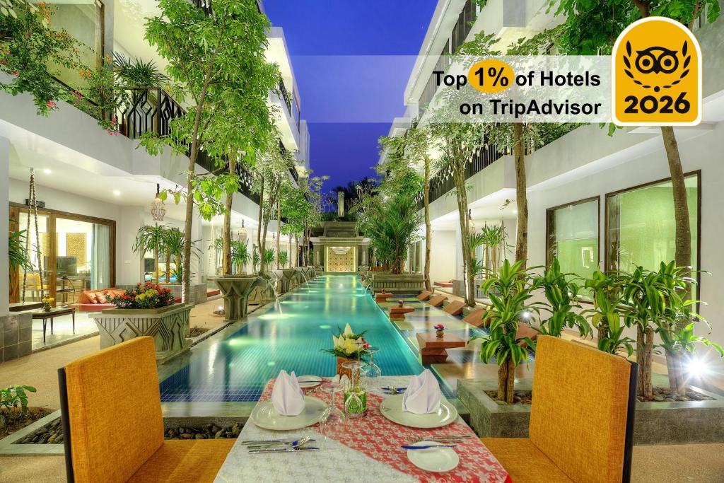 a restaurant with a pool in a building at Golden Temple Retreat in Siem Reap