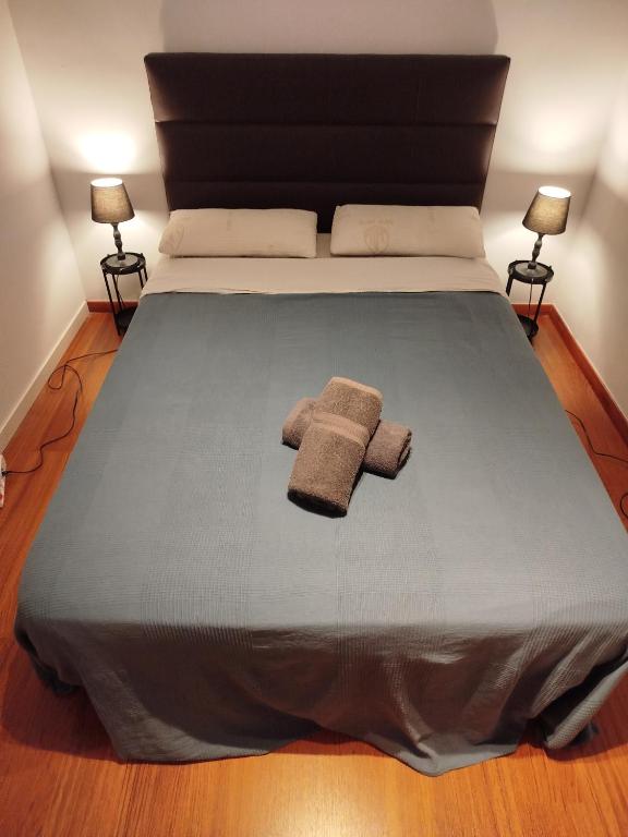 a bed with two towels sitting on top of it at Rooms in the center City in Barcelona