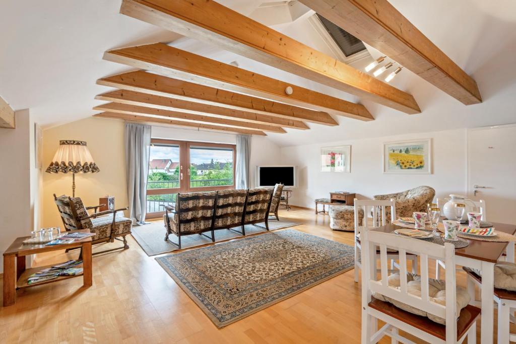 a living room with wooden ceilings and a table at Haus "Sonnenblume" in Regenstauf