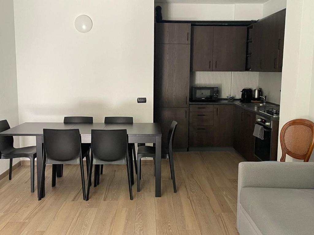 a kitchen and dining room with a table and chairs at Appartamenti Sky Express in Campodolcino
