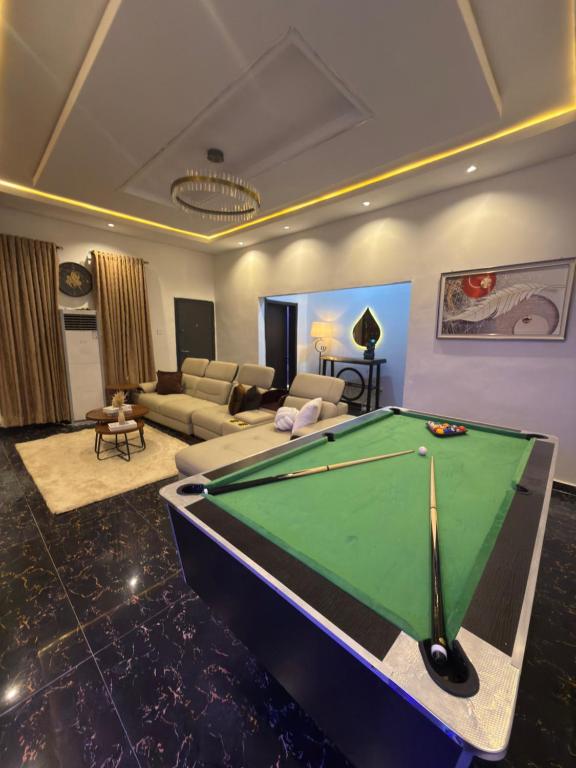 a living room with a pool table in it at EK Escape and Suites in Ado Ekiti