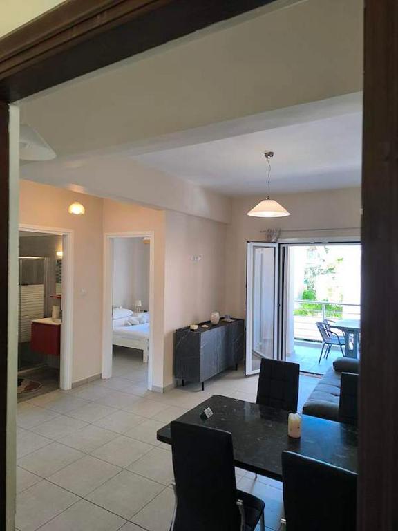 a living room with a dining table and a living room at George apartment in Artemida
