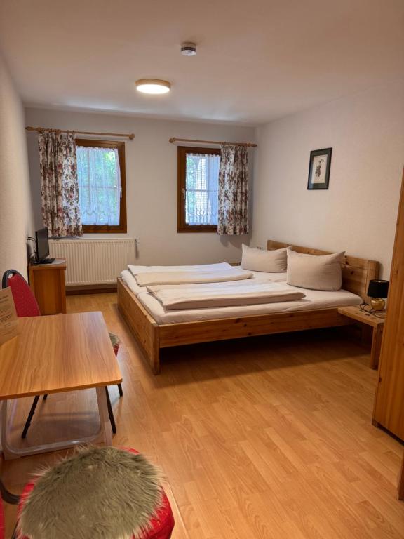 a bedroom with a large bed in a room at Hotel Maien in Todtmoos