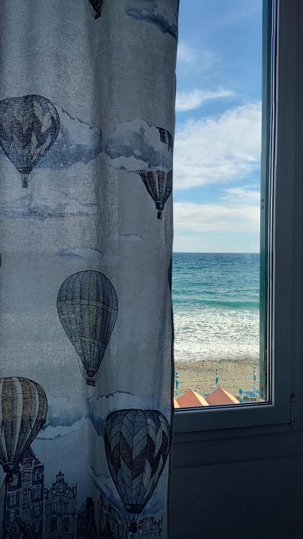 a window with a view of the beach and the ocean at B&B BnBeach in Varazze