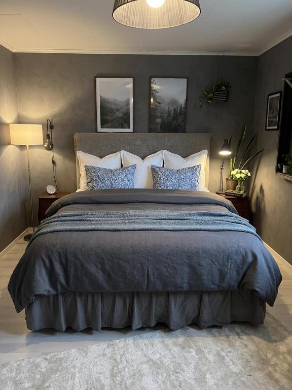 a bedroom with a large bed with blue sheets and pillows at Skid vm in Falun