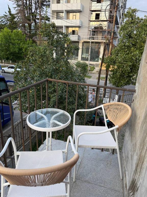 two chairs and a table on a balcony at Green Home in Kobuleti