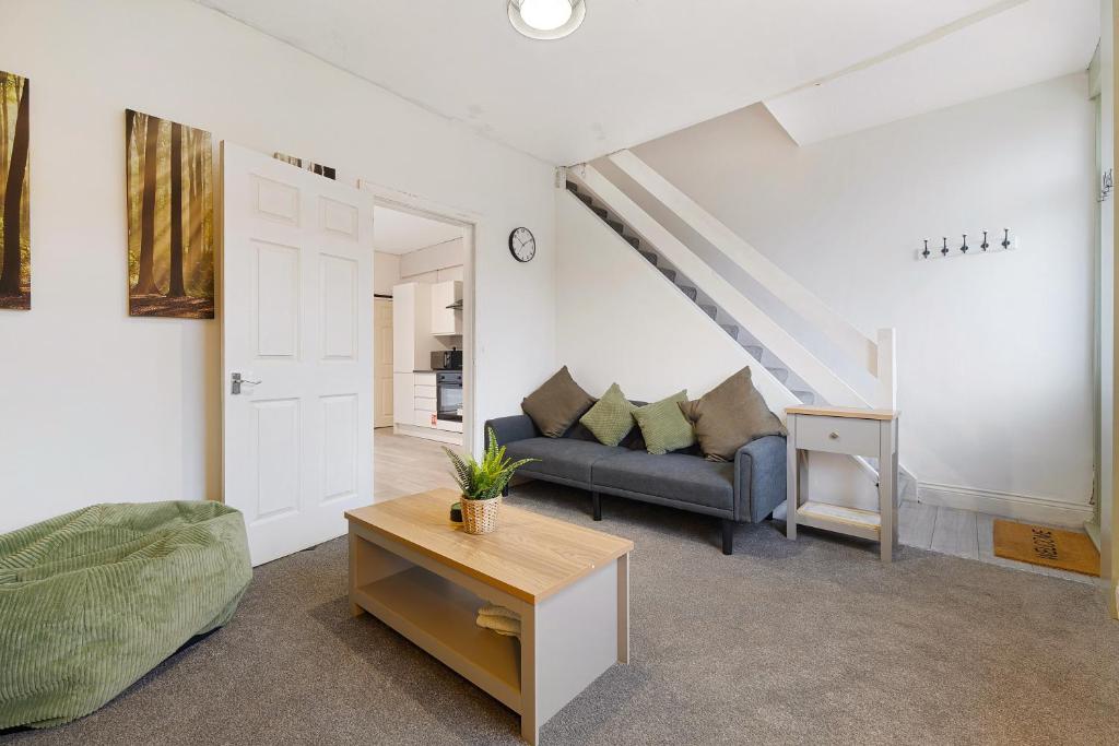 a living room with a couch and a table at Cosy 2BR Apartment Sleeps 4 by Stay With Us in Hawthorn