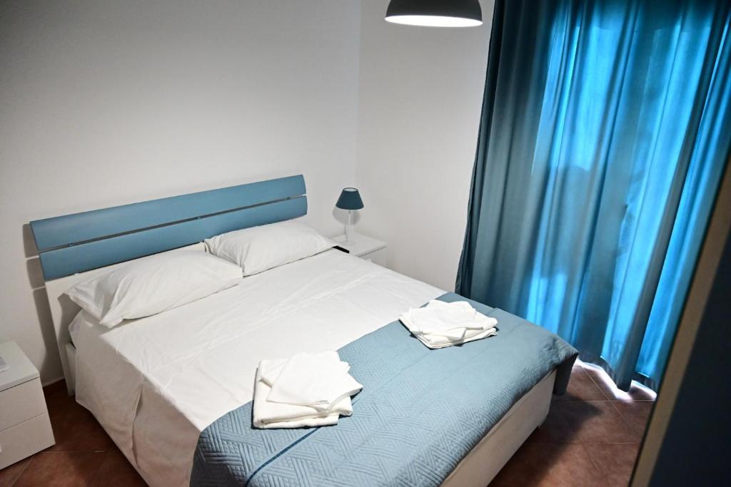 a bedroom with a bed with two towels on it at Casa Marina in Balestrate