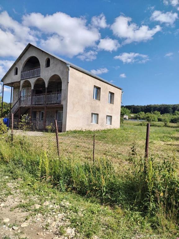 an old building in the middle of a field at Ghulelebi - ღულელები in Ghulelebi