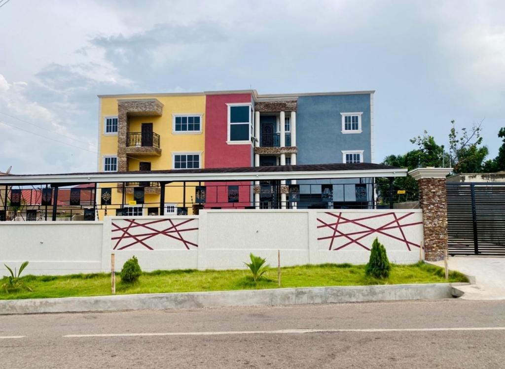 a building with a fence in front of it at Simon donkor 2 in Kumasi