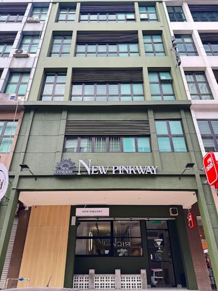 a building with a new pharmacy sign in front of it at USJ NPW New PinkWay Hotel in Subang Jaya