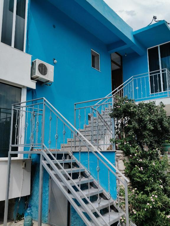 a blue house with stairs in front of it at BNB Alehandro in Radhimë