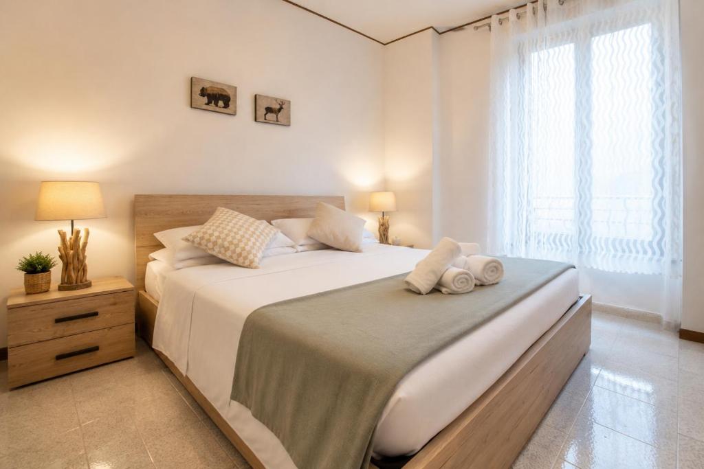 a bedroom with a large bed and a window at Luna al Monte in Cuasso Al Monte