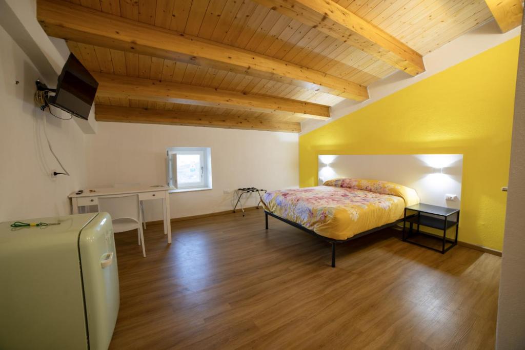 a bedroom with a bed and a desk in a room at B&B Anele in Morano Calabro