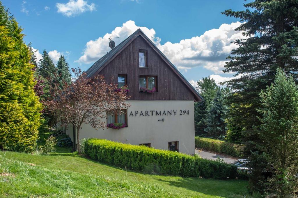 a barn with a sign on the side of it at Apartmány 294 in Bedřichov