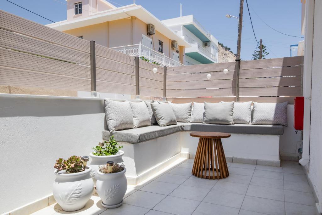 a balcony with a bench and potted plants on it at Villa Maria in Voládha