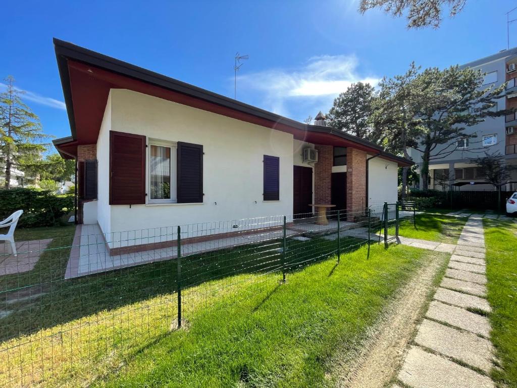 a house with a fence in front of it at Villa Raffaella - Privat Garden in Bibione