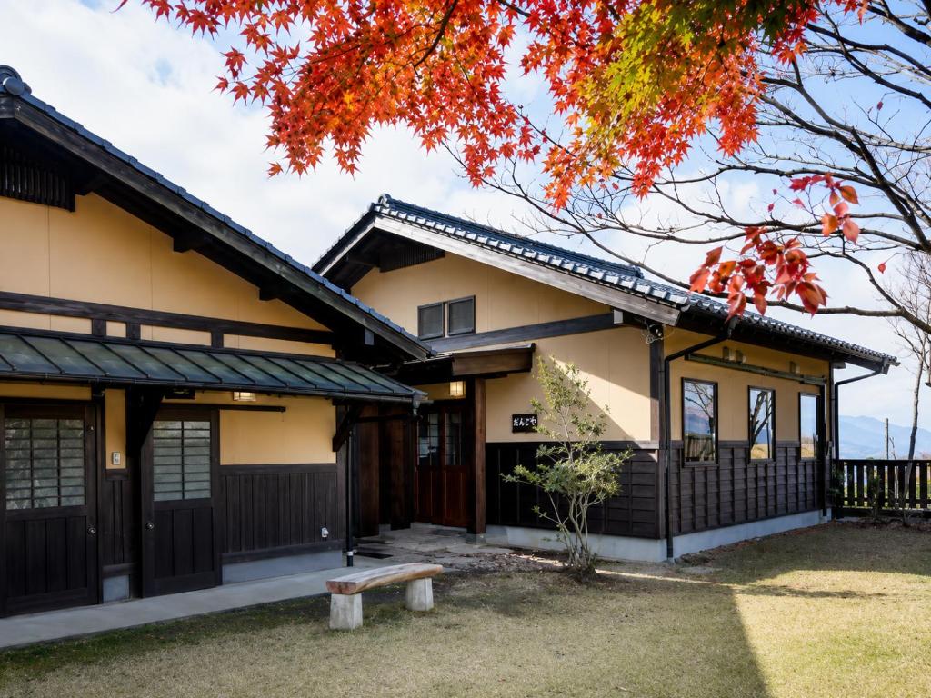 a house in the fall with a tree at 御宿だいこんや in Takamori