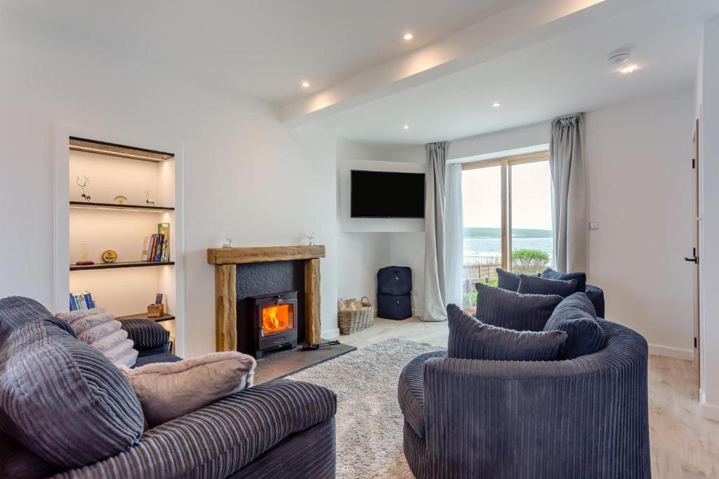 a living room with two couches and a fireplace at 2 Bed in Thurso oc-n41742 in Thurso