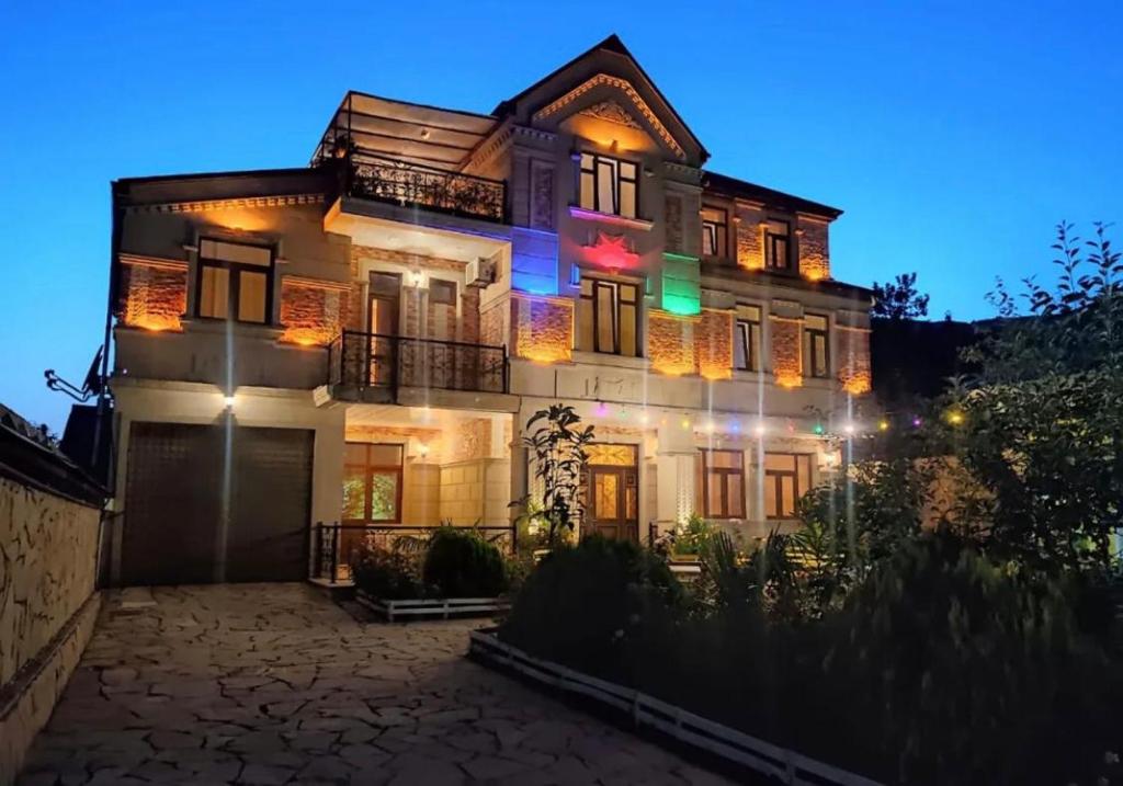 a large house with lights on it at night at Sheki Villa boutique in Sheki