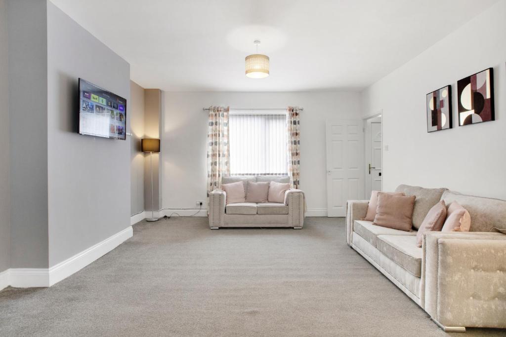 a living room with a couch and a chair at Stylish 2BR House in Ashington by Stay With Us in Ashington