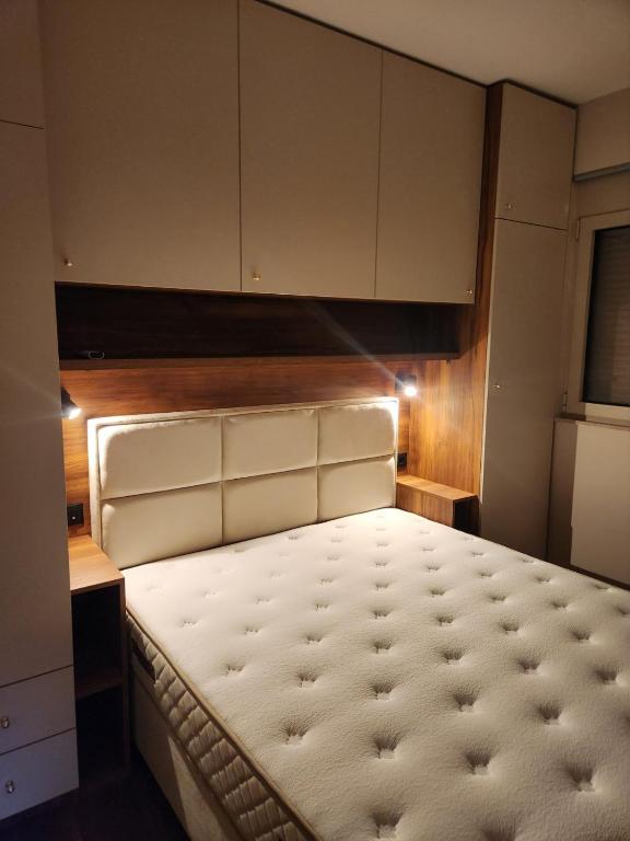 a bedroom with a large bed in a room at Apartman Bloom 6 in Tivat