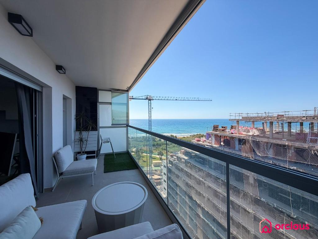 a room with a balcony with a view of the ocean at Altamar Imperial in Cabanes