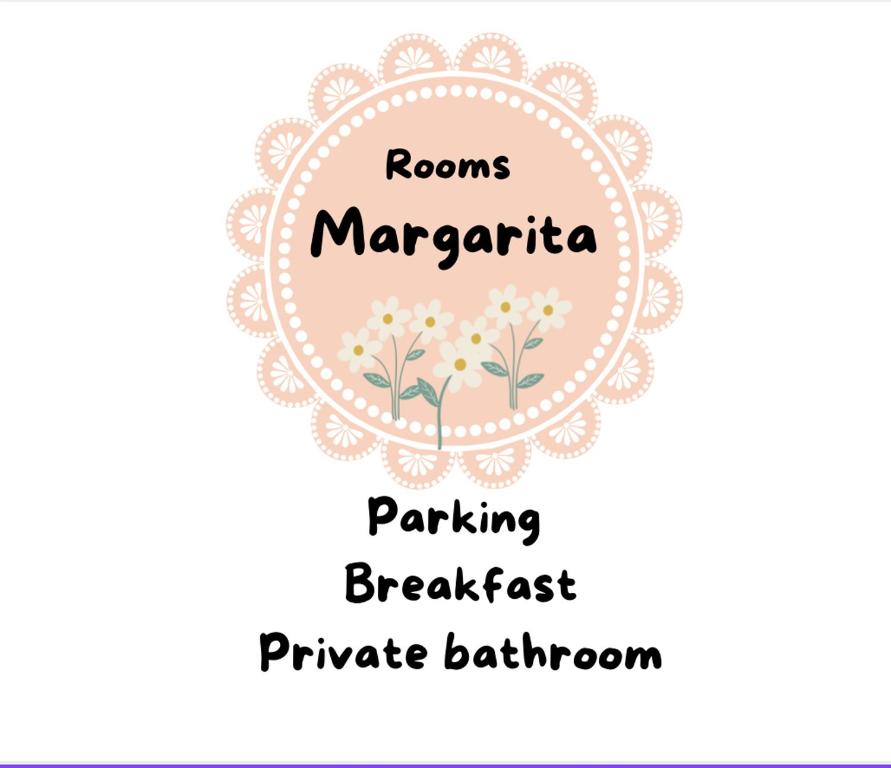 a sign that reads rooms margarita parking breakfast and private bathroom at Rooms Margarita in Zadar