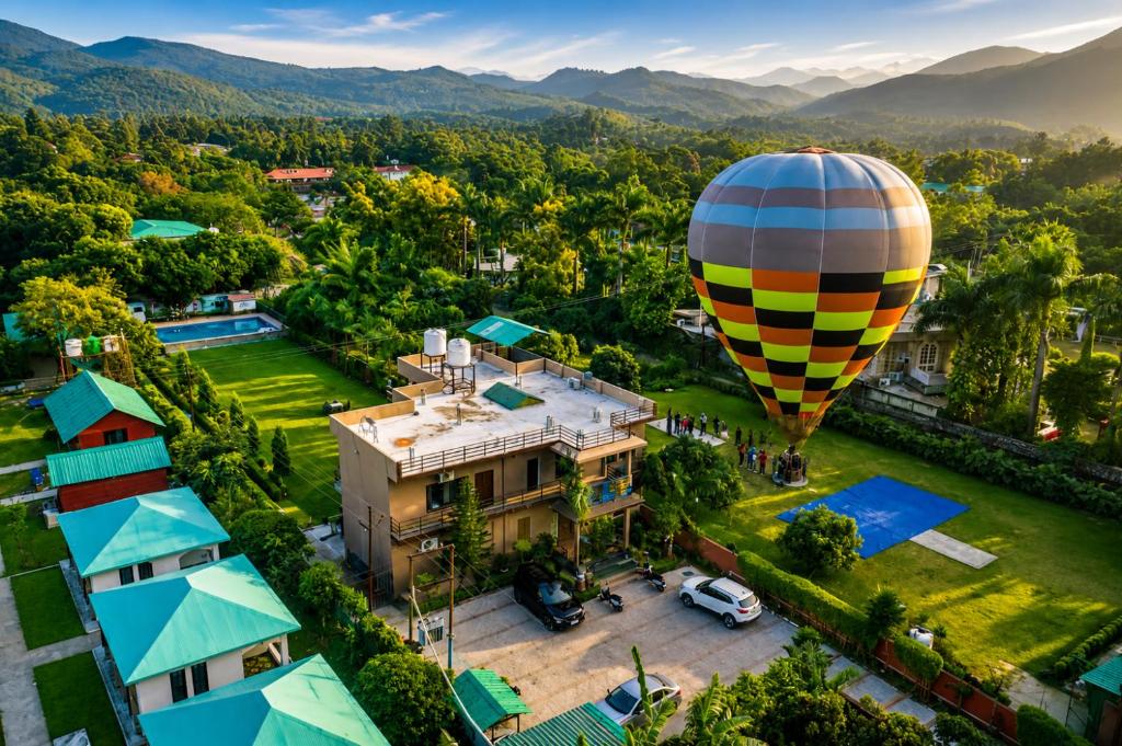 an hot air balloon flying over a house at Wildline Gold Resort in Dhikuli