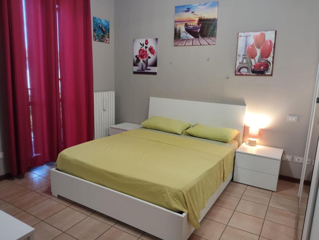 a bedroom with a bed and red curtains at Casa Maria 3 in Cigole