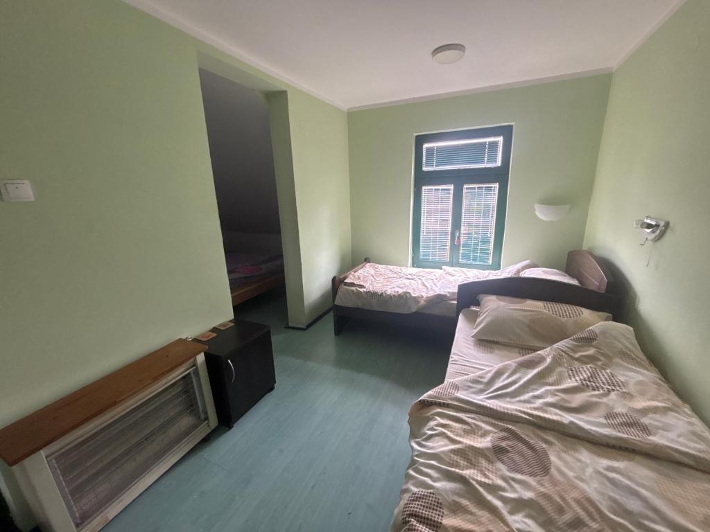 a room with two beds and a window at Staro Lane in Sjenica
