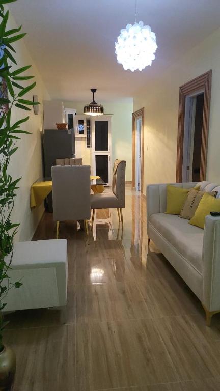 a living room with a couch and a table at Enjoy Life Holidays in Andrés
