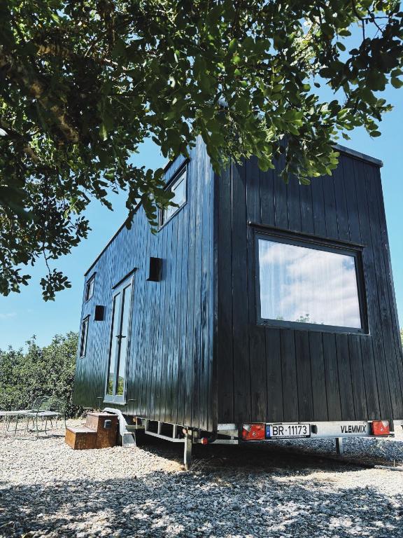 a black tiny house with two windows at Tiny House in Pereiro
