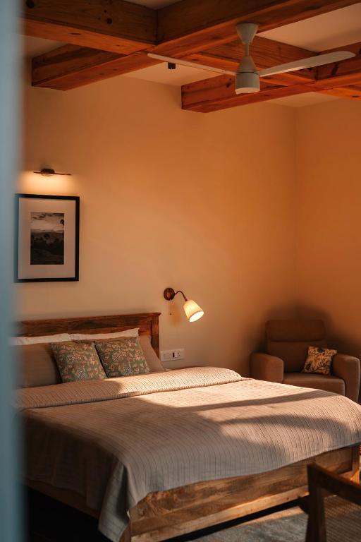 a bedroom with a large bed and a couch at The Chitai Life in Almora